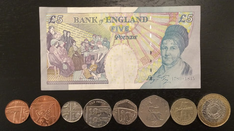 England Pound currency bill coins